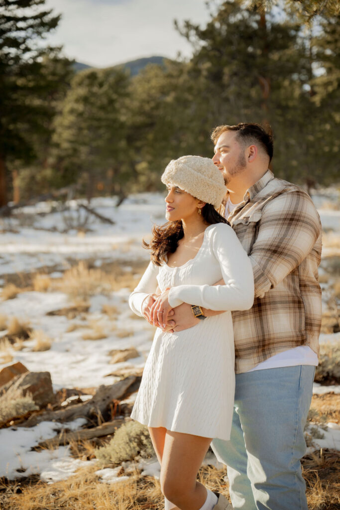 Couple cuddling in a snowy landscape