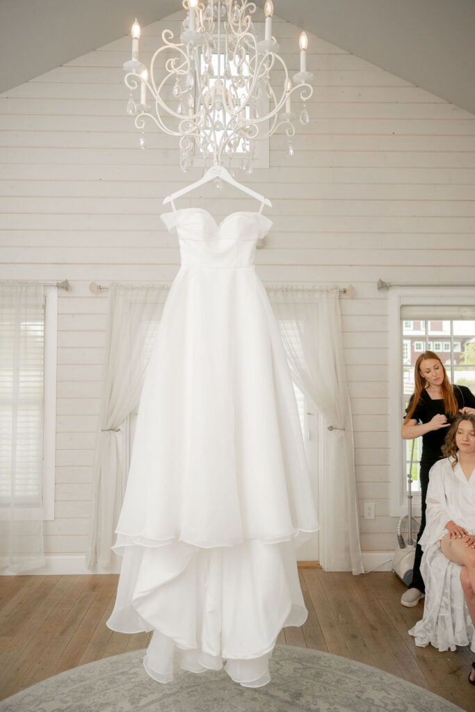 The dress hung beneath the chandelier