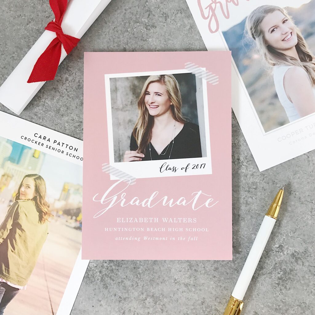 "Graduate" announcement card with photo, surrounded by other graduation cards.
