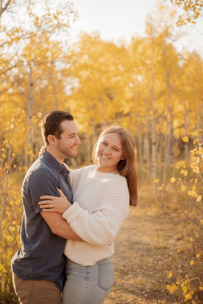 Couple Embracing in a Golden Autumn Forest