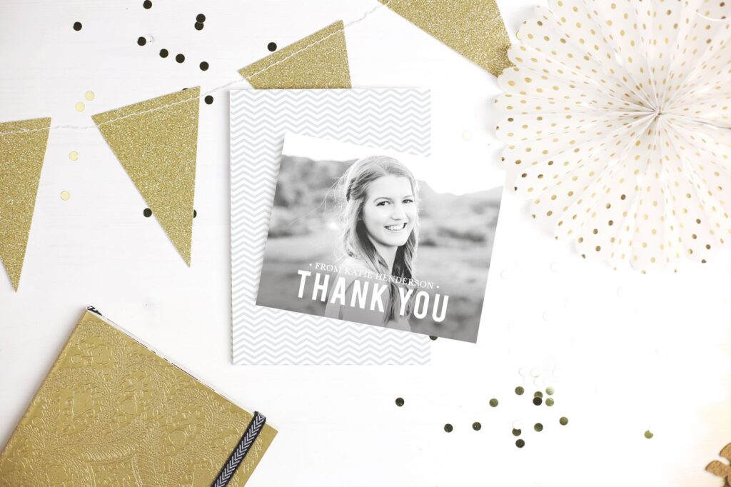 "Thank You" graduation card with a photo, surrounded by party decorations.
