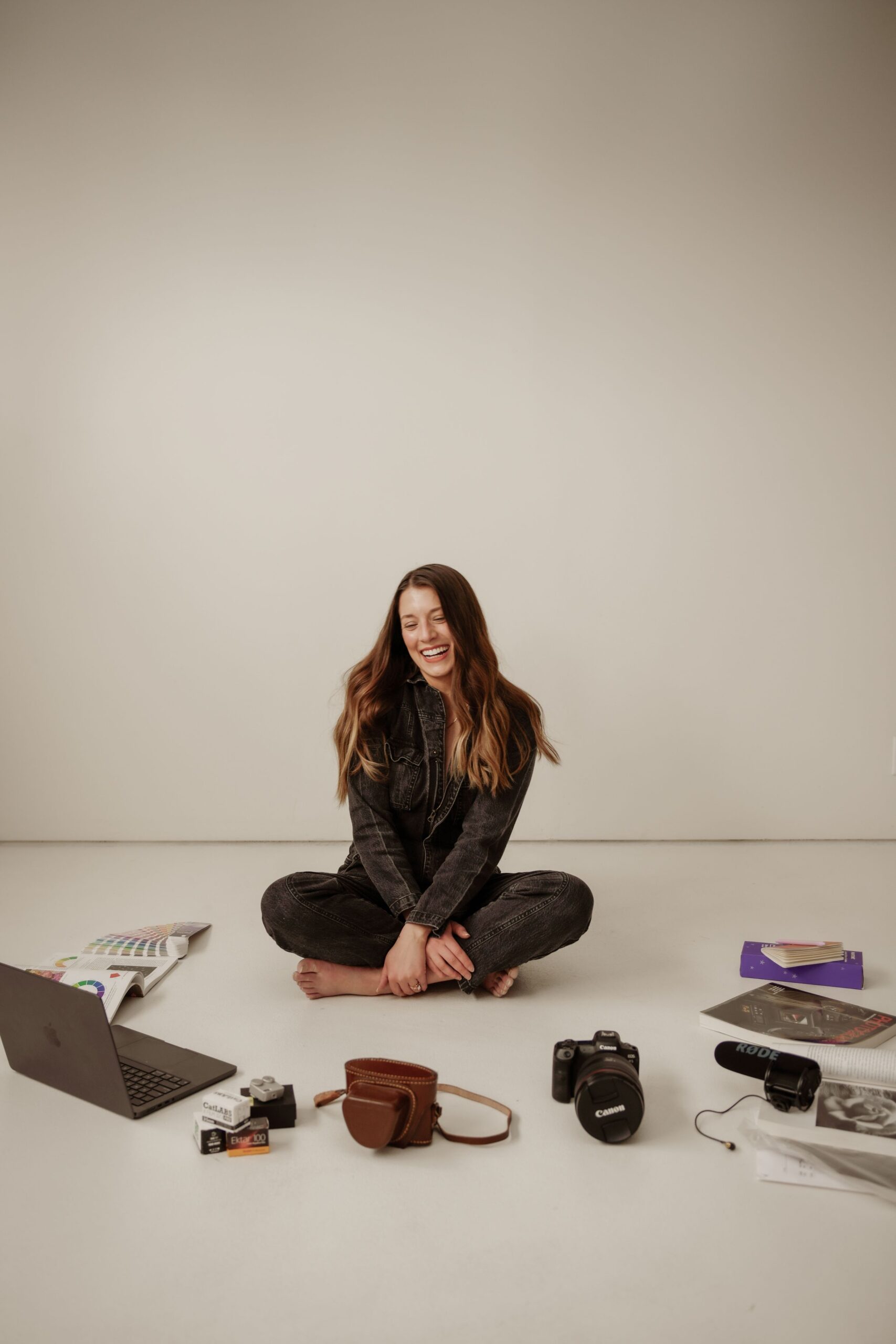 Personal branding photographer with camera and creative tools in studio