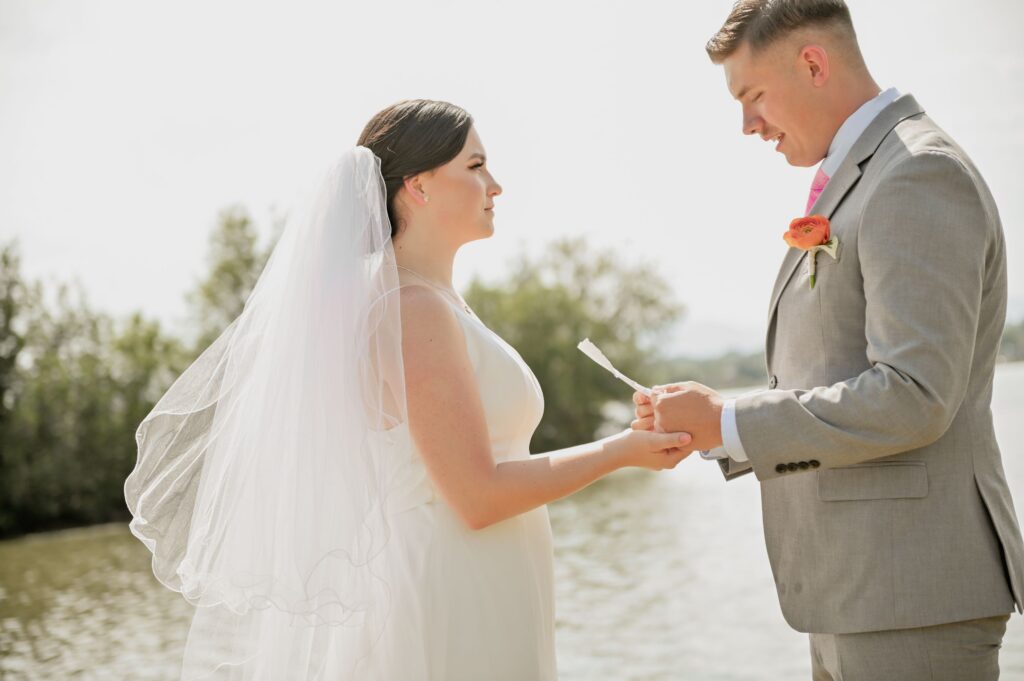 Bride and groom holding hands during their wedding vows.