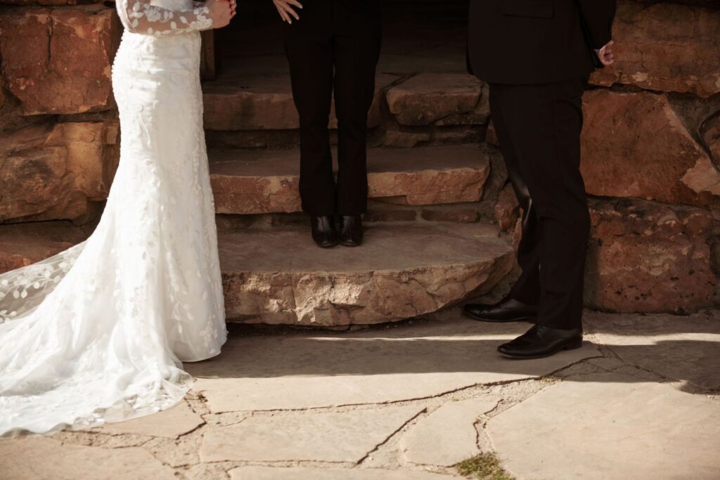 Bride and groom standing together during an outdoor wedding ceremony.