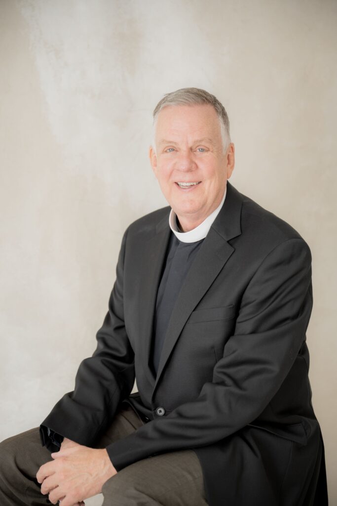 Priest smiling during a professional portrait session