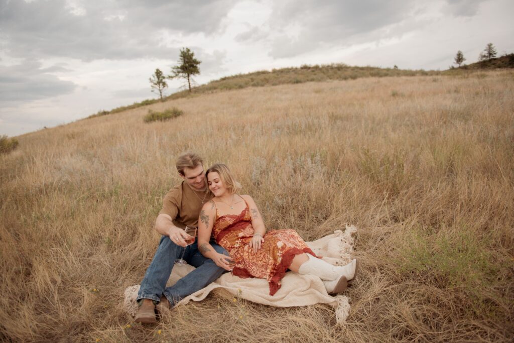 Romantic Couple Picnic in Open Meadow at Golden Hour