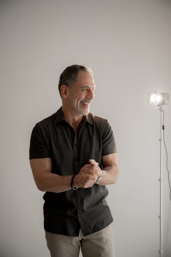 Smiling man standing in a photography studio during a portrait session