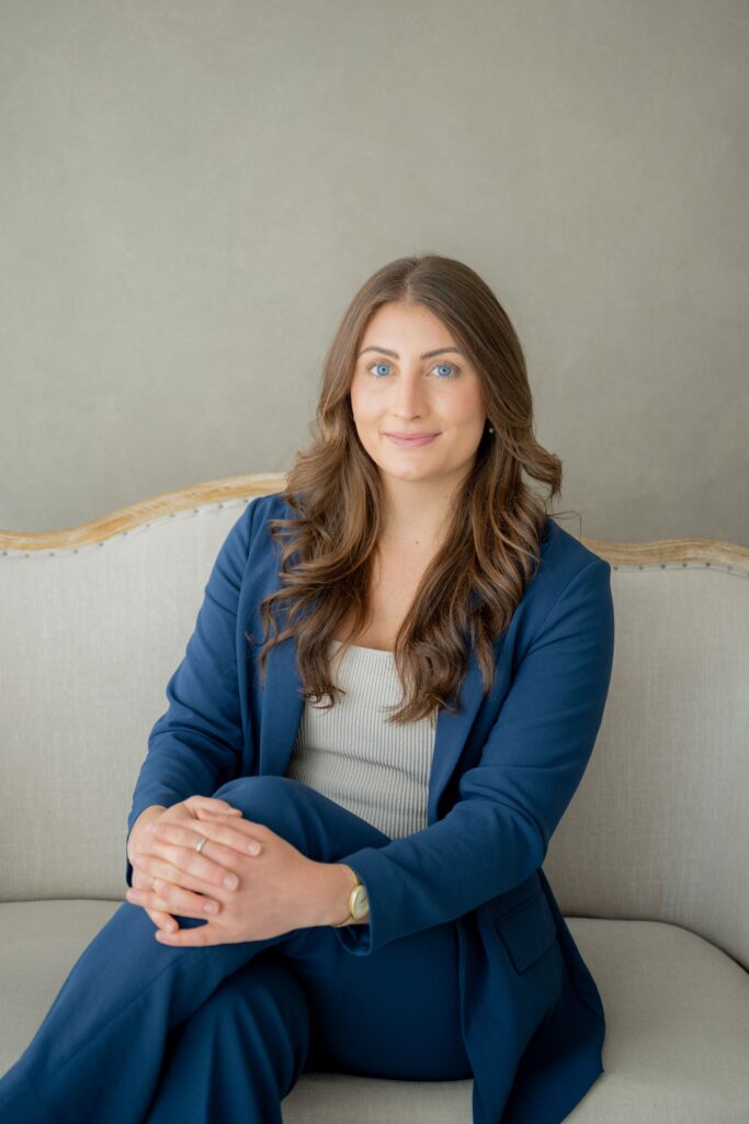 Woman in blue suit sitting for a professional portrait