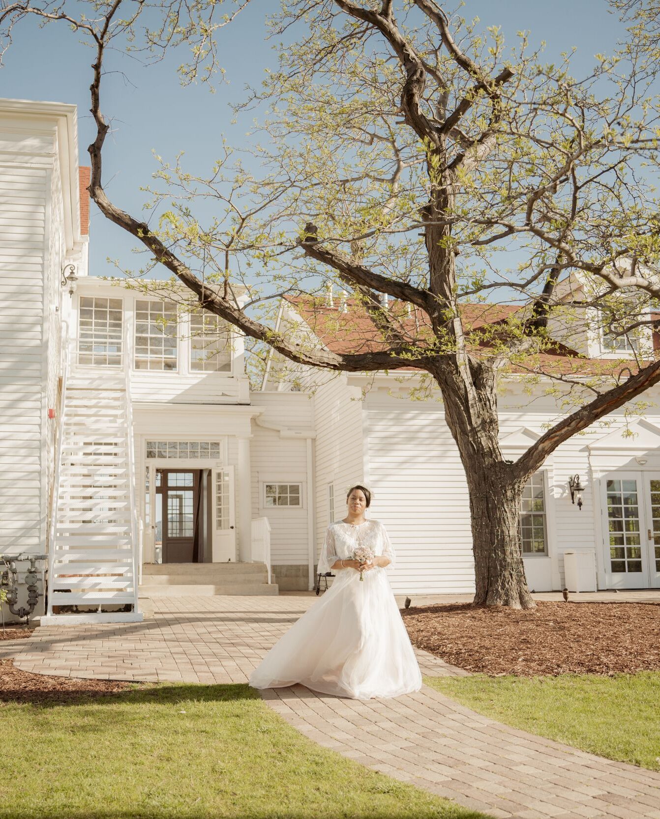 Bride Outside a White Wedding Venue