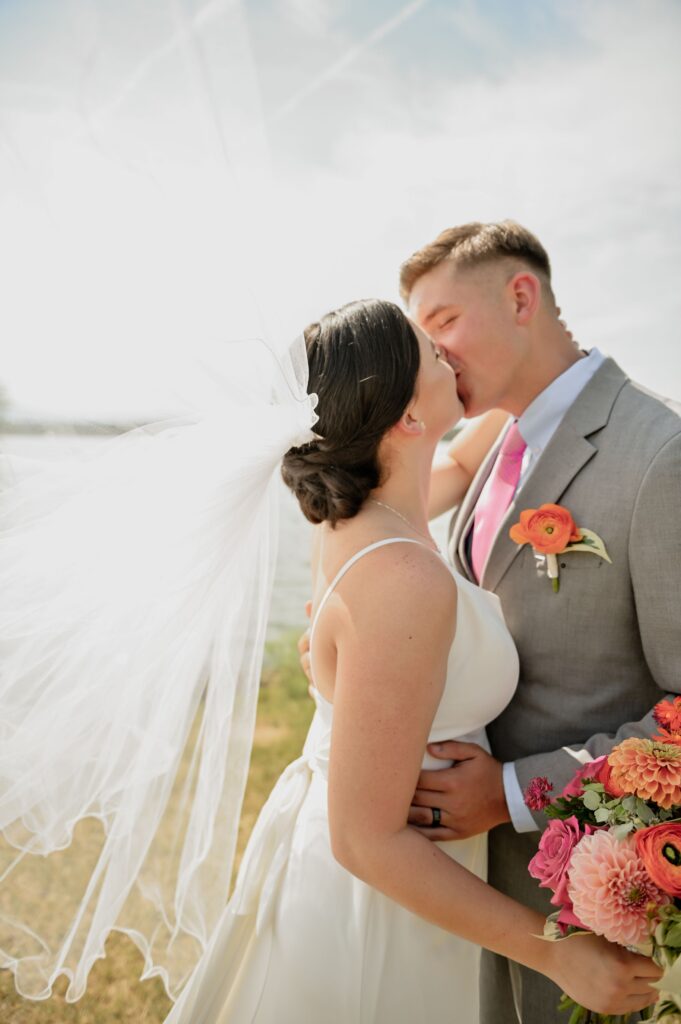 Bride and Groom First Kiss by the Lake
