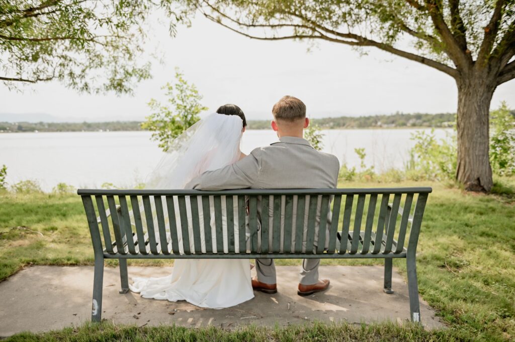 Bride and Groom Sitting on a Park Bench