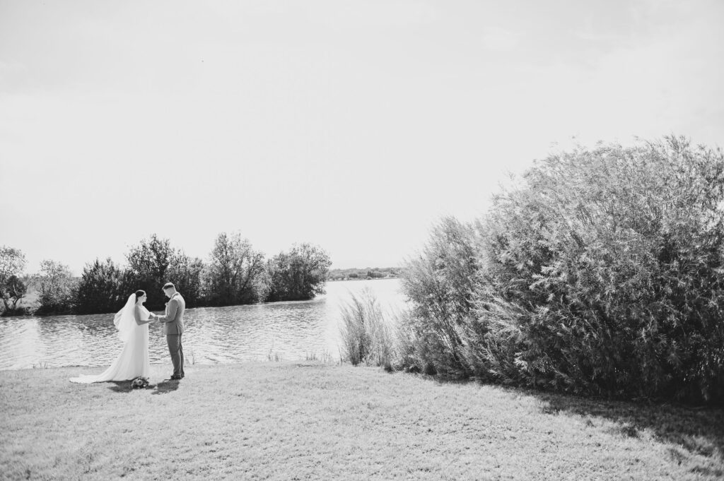 Bride and Groom by the Lake on Their Wedding Day