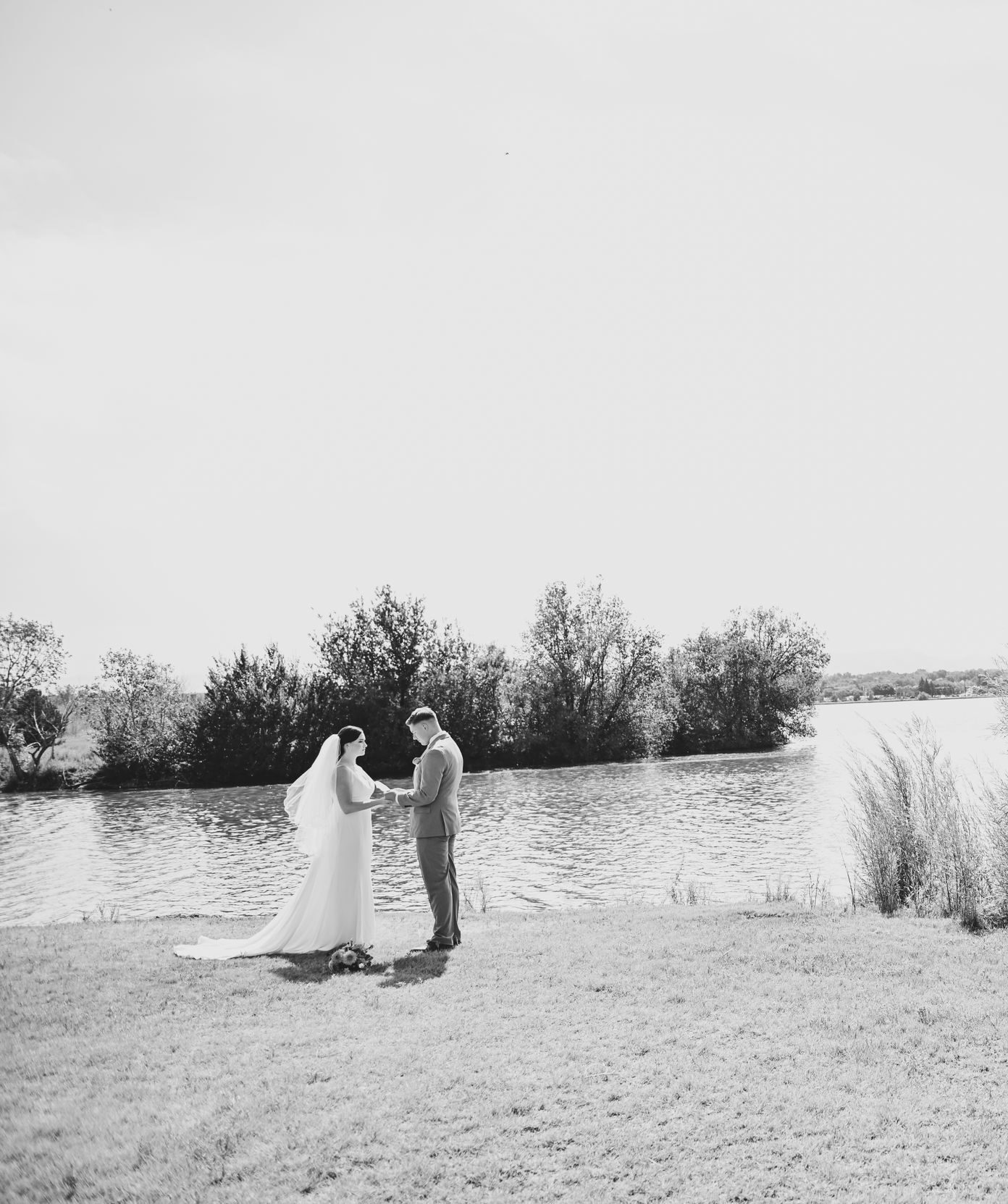 Bride and Groom by the Lake on Their Wedding Day