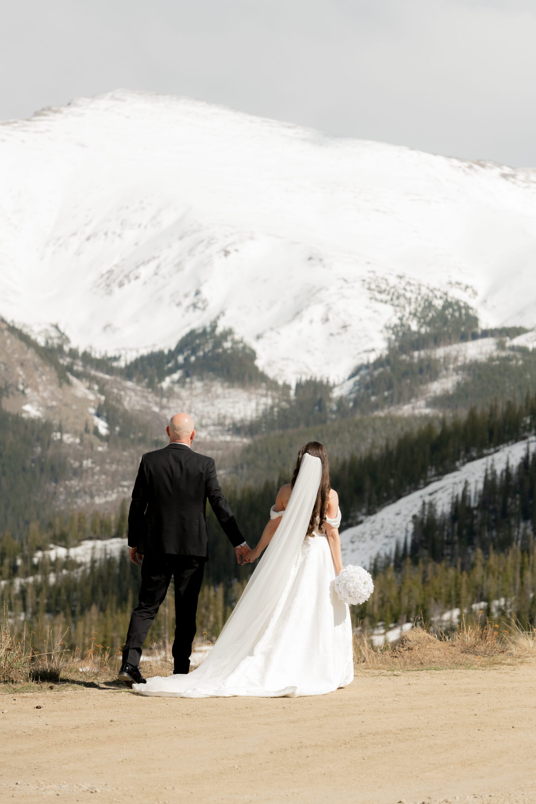 Bride and groom with mountain view at sunset