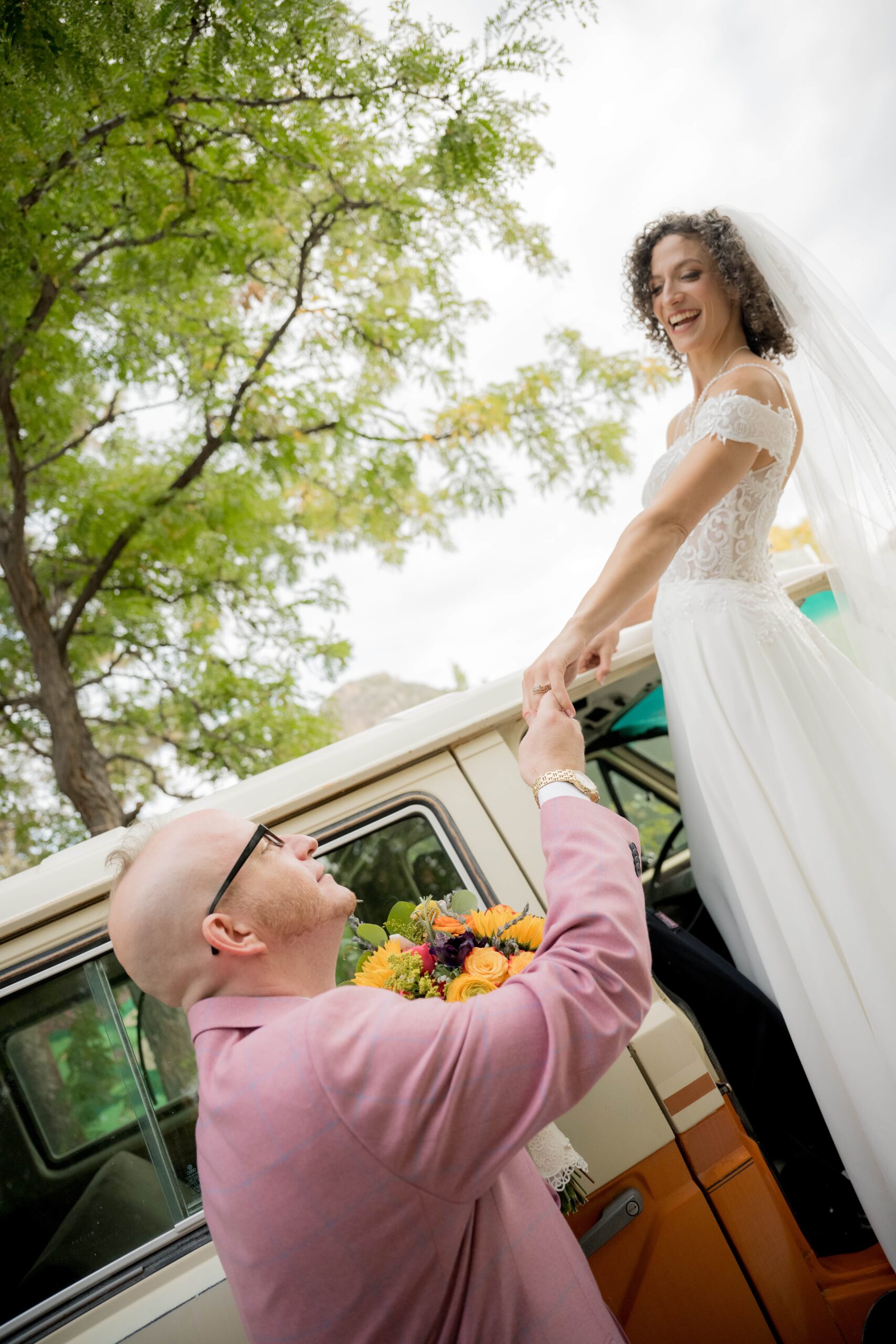 Bride stepping from vintage van