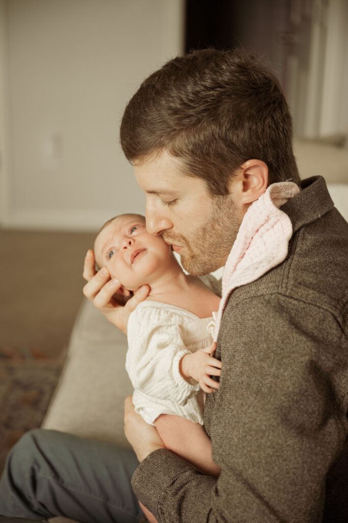 Father kissing the newborn