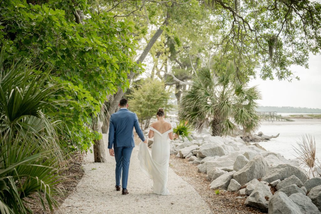 Groom holding Bride dress