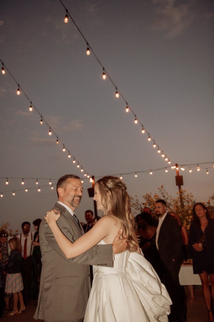 Newlyweds Dancing at Sunset Reception