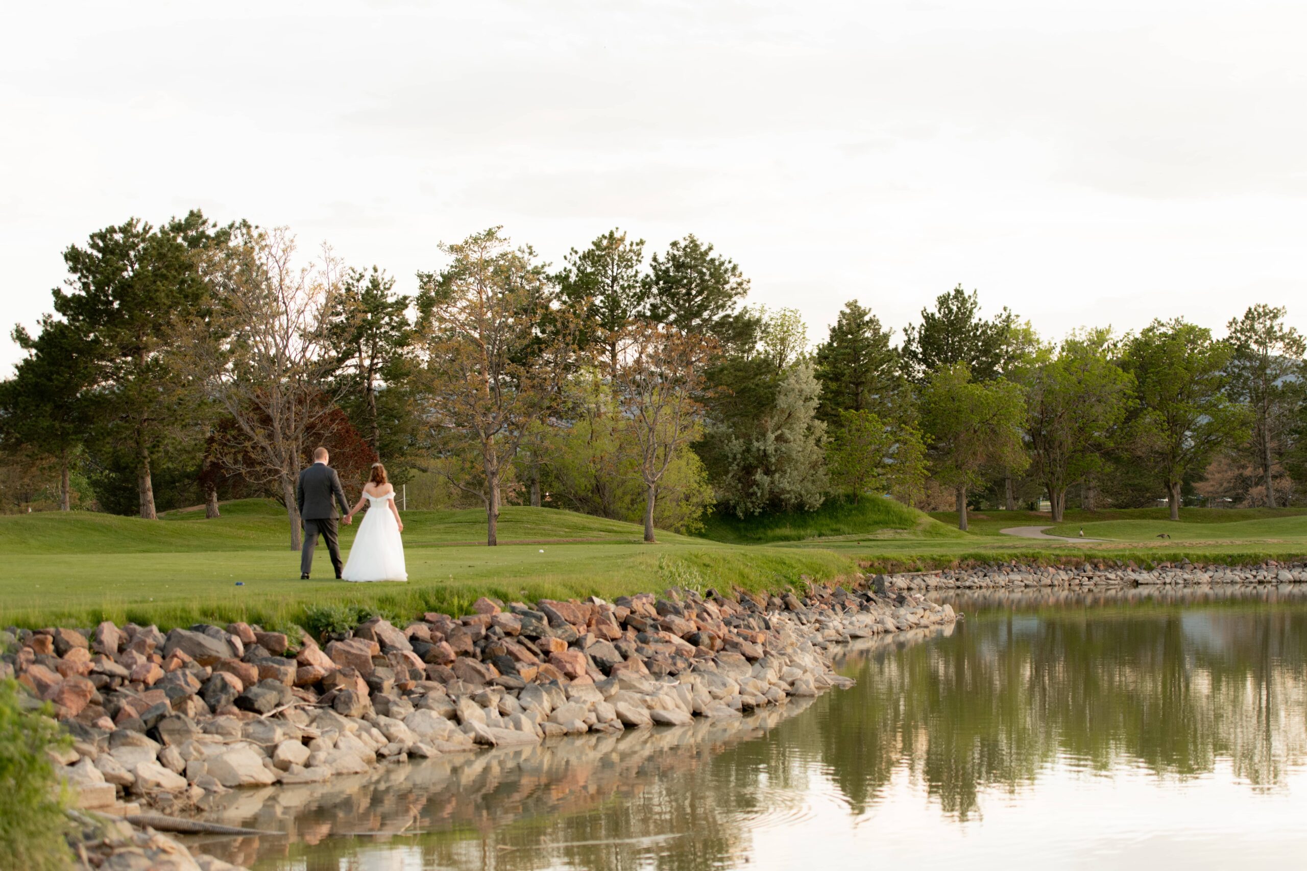 Bride and groom by the lake