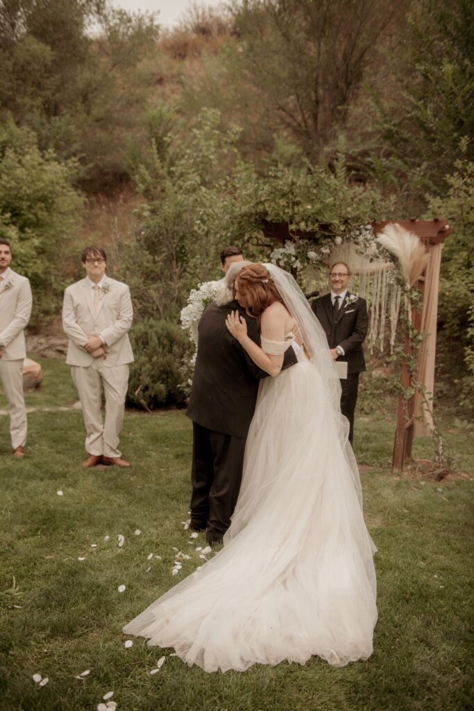 Bride hugging her father